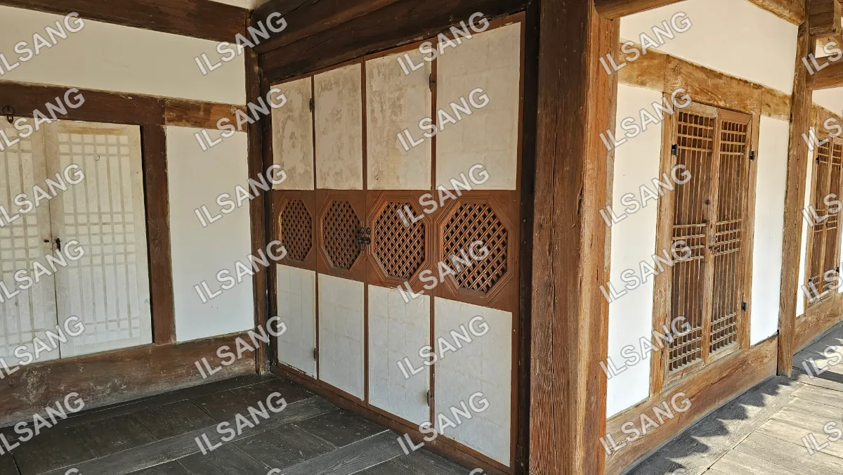 A wooden door with a white panel on it.