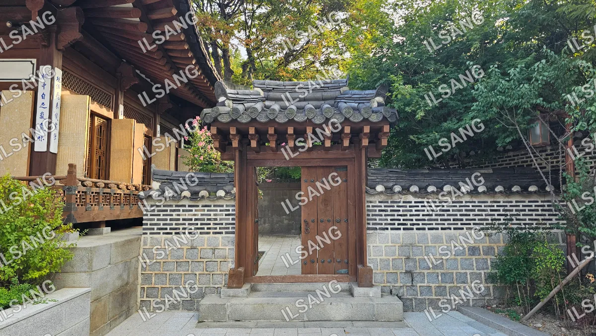 A wooden doorway with a tile roof.