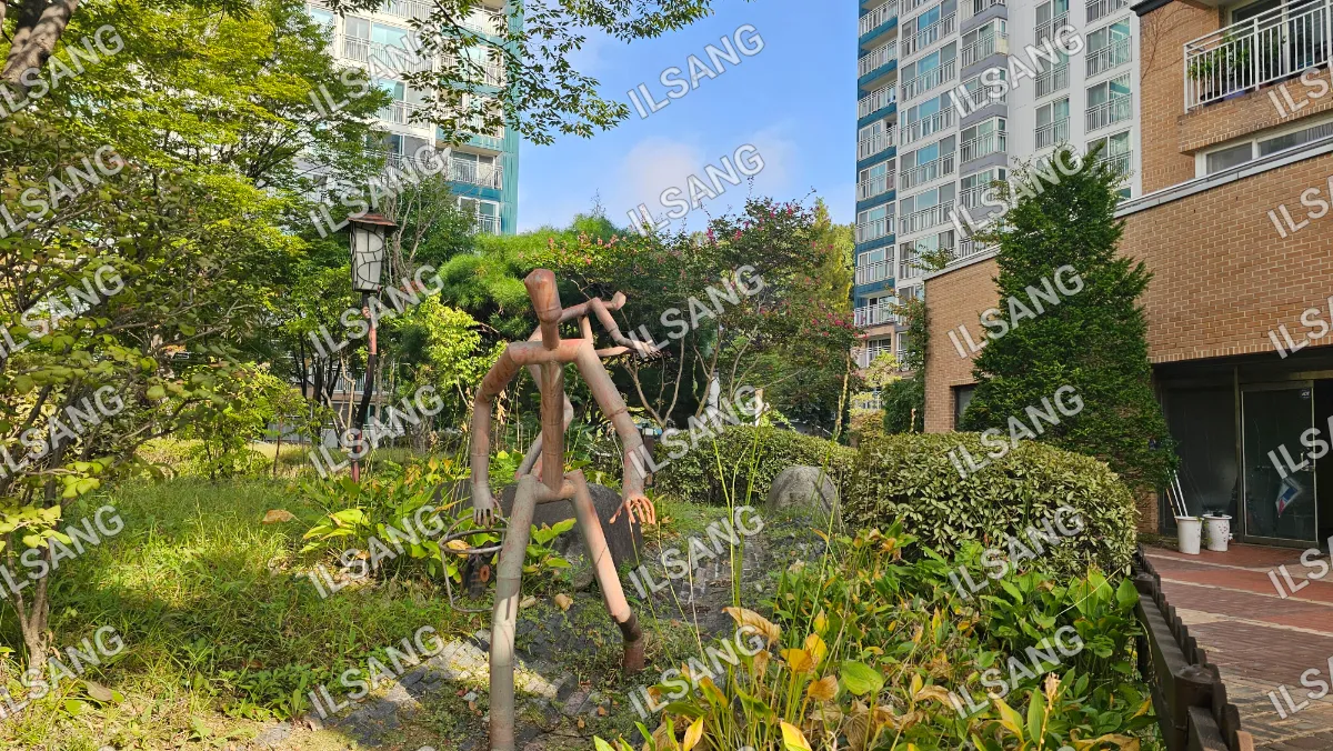 A wooden statue of a man with a bird on his shoulder.