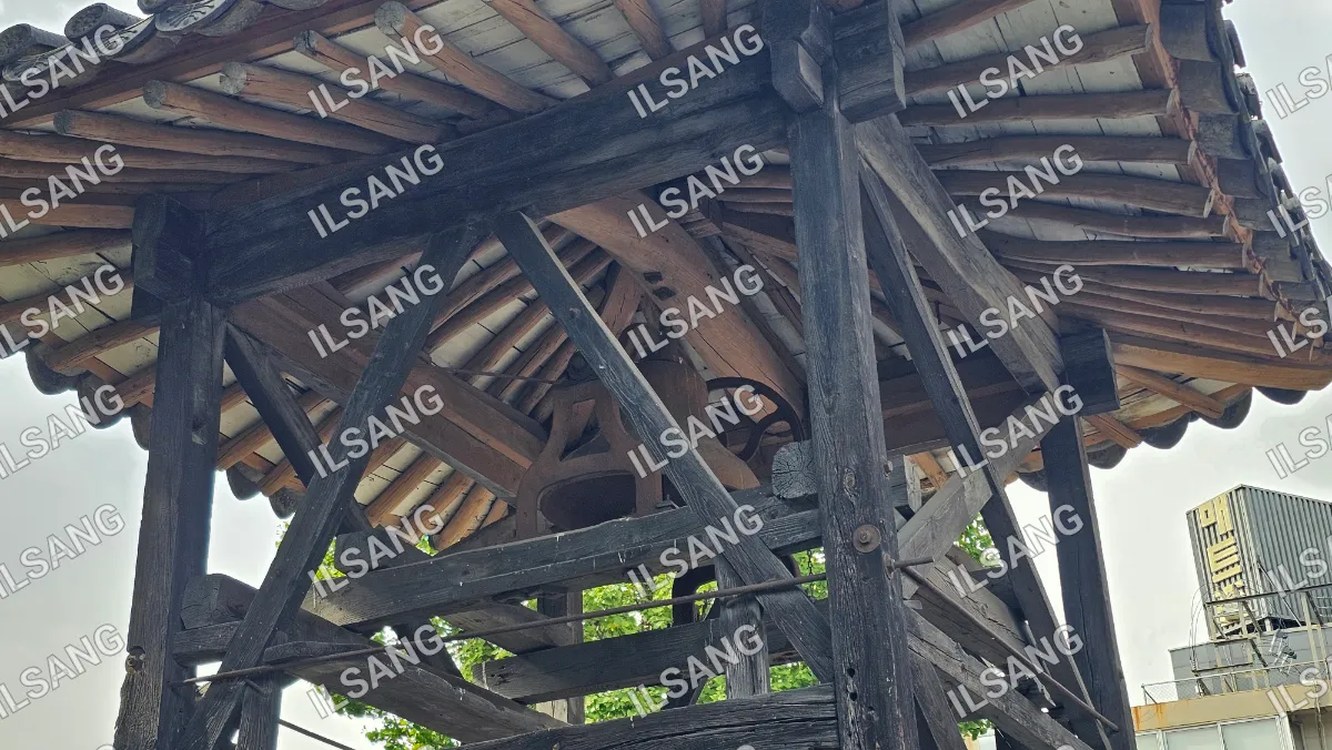 A wooden structure with a large wheel on top.