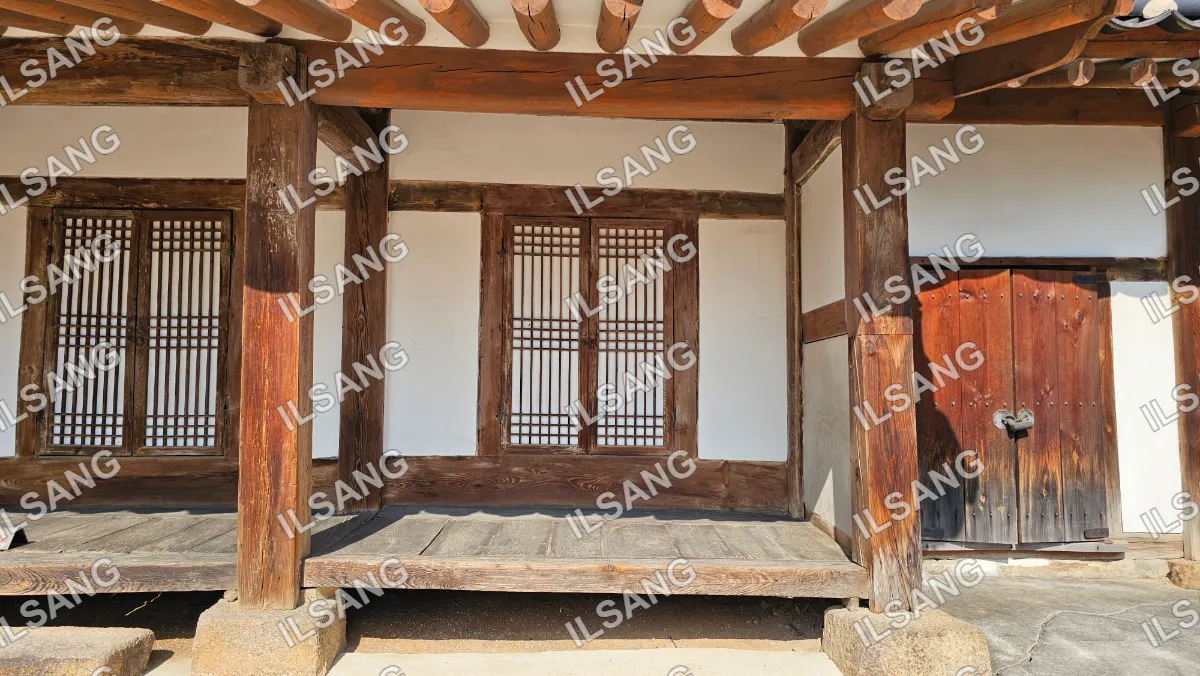 A wooden structure with a window and a door.