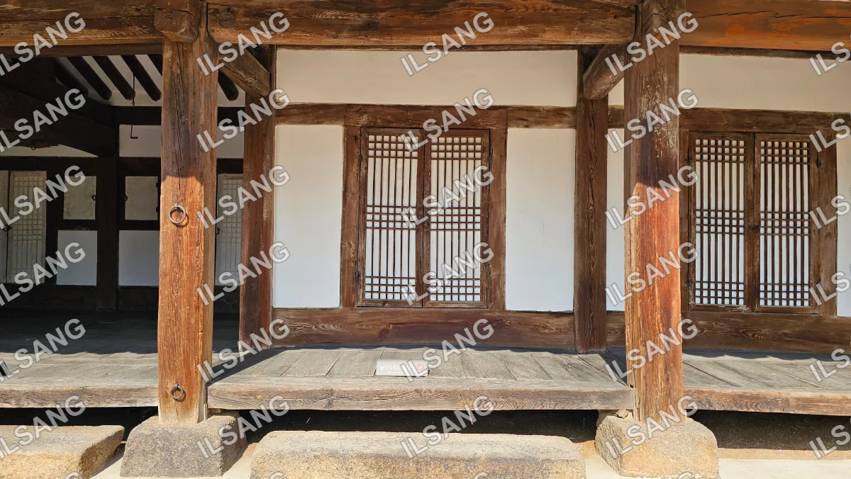 A wooden structure with a window and a door.
