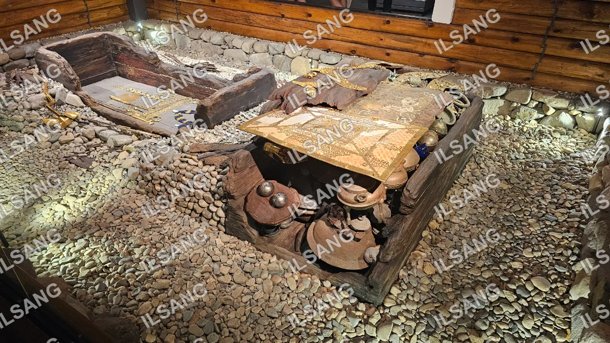 A wooden table with a gold tablecloth on top of it.