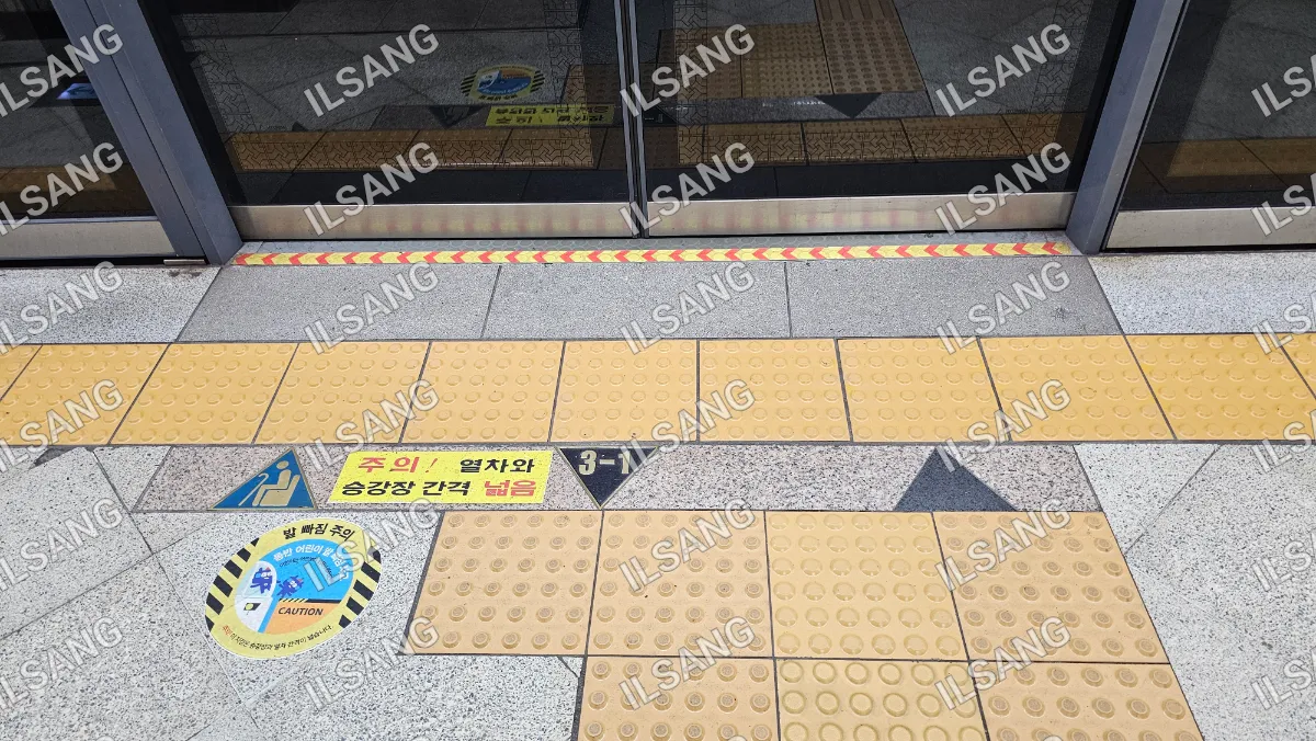 A yellow and black tile floor with a sign that says "3-1" on it.