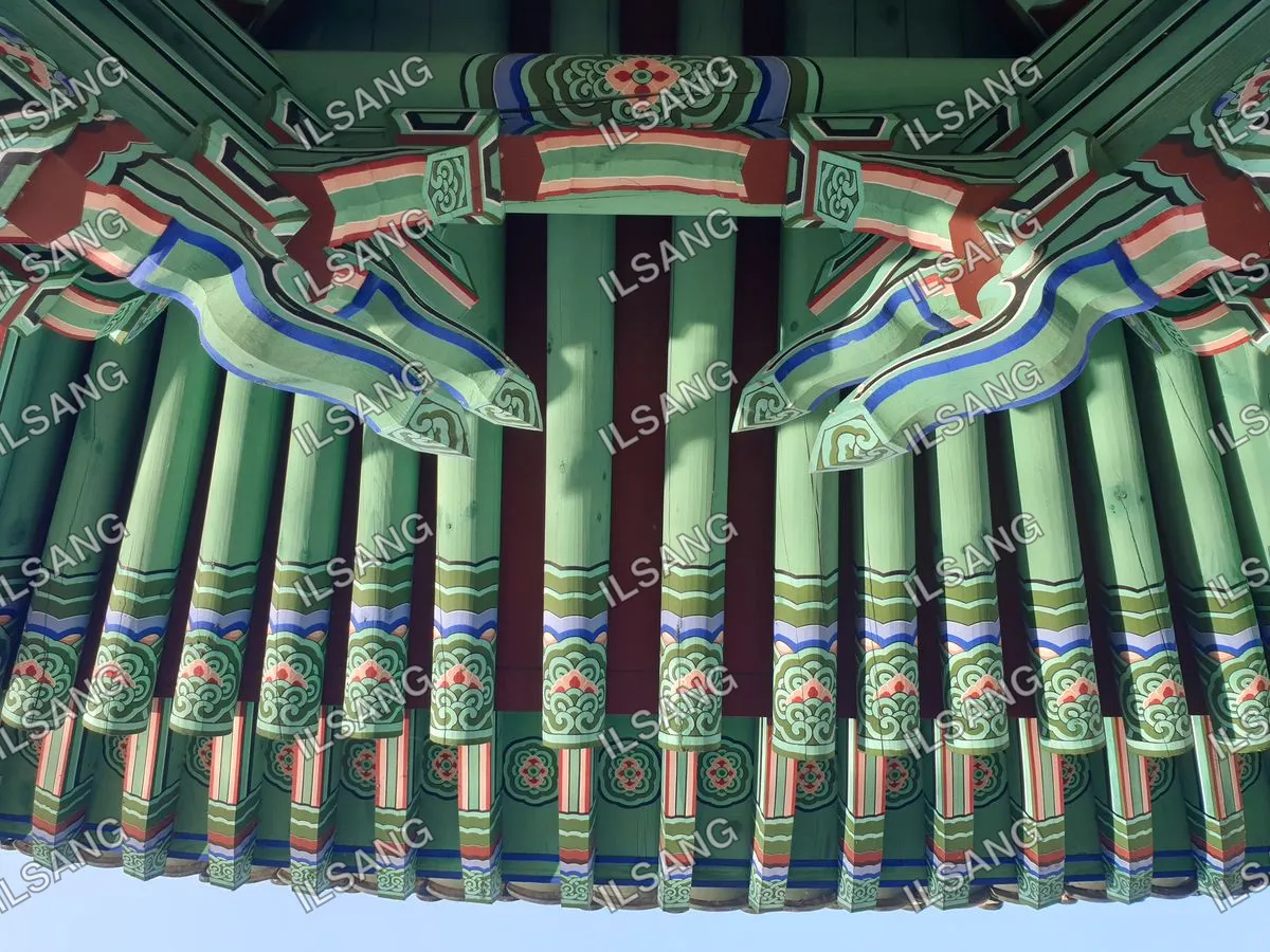 A green and blue painted wooden structure with a blue and green painted roof.