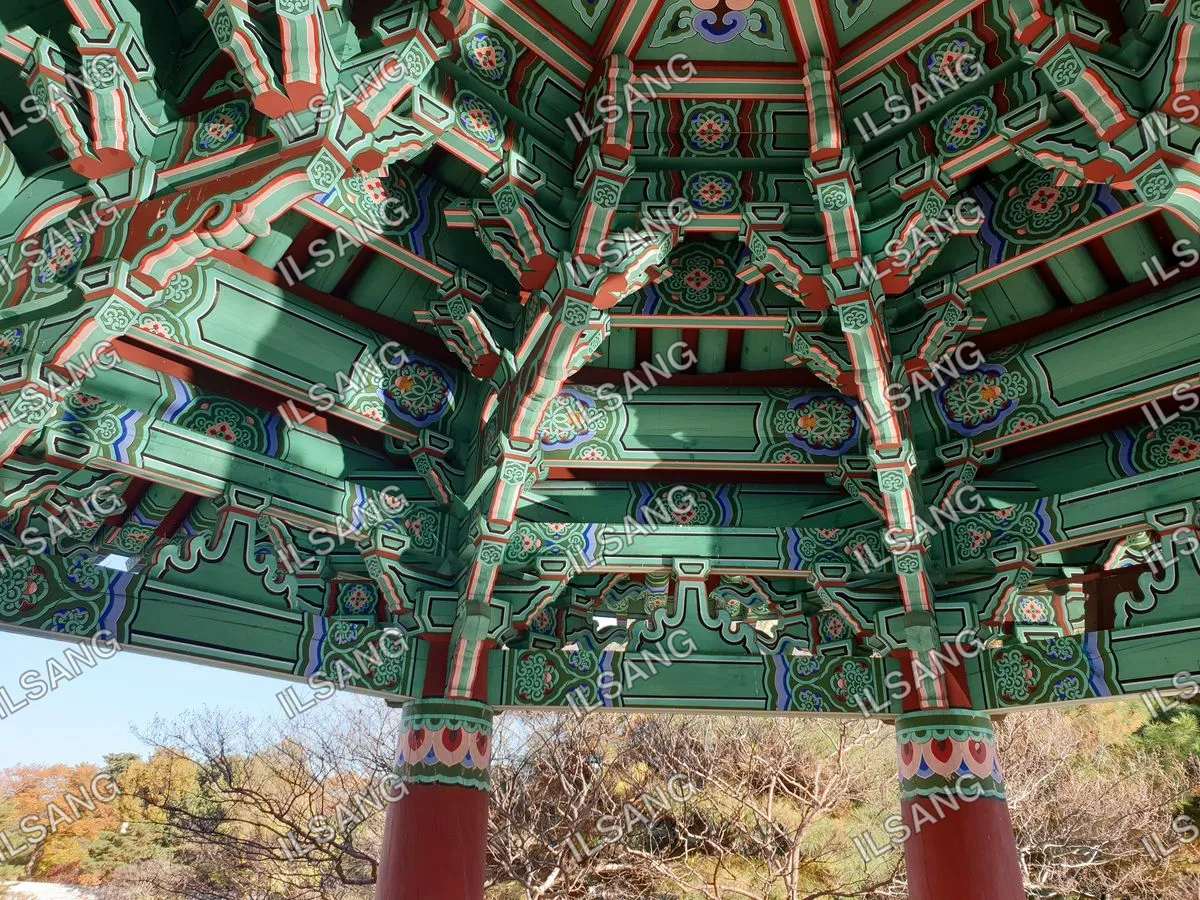 A colorful wooden structure with a green roof.