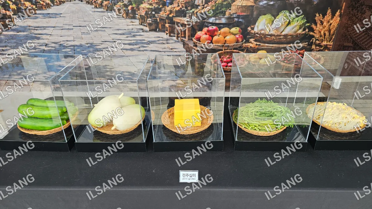 Three glass cases display a variety of foods.