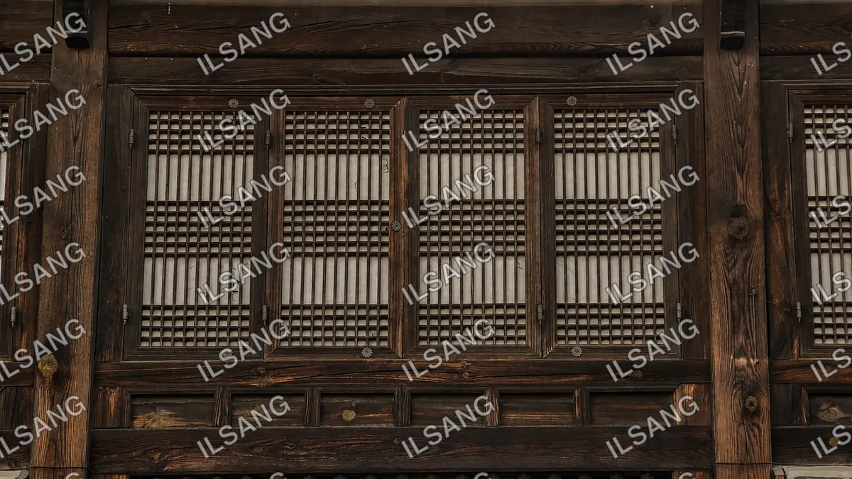 A wooden cabinet with a white grate on the door.