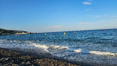 A beautiful blue ocean with waves crashing on the shore