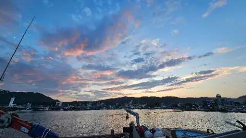 A beautiful sunset over a lake with a boat in