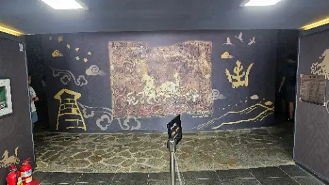 A black and gold painting on a wall