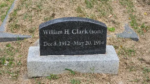 A black gravestone with the name William H. Clark
