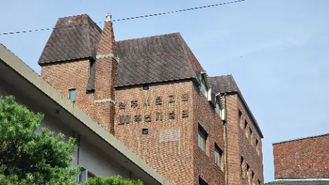 A brick building with a sign on the side that