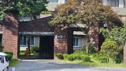 A brick building with a tree in front of it