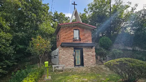 A brick church with a cross on top