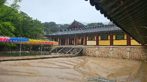 A building with a red roof and yellow banners