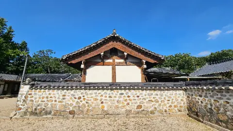 A building with a tile roof and a bird on