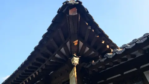 A building with a triangular roof and a light on