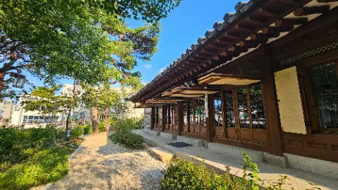A building with a wooden roof and a stone wall
