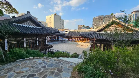 A city street with a building and a stone walkway
