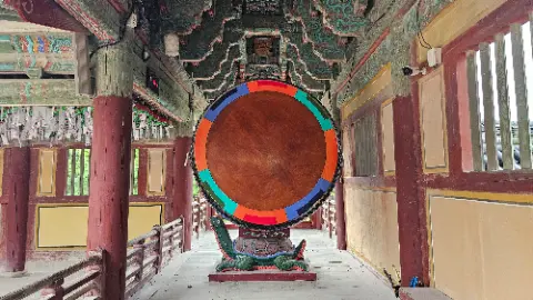 A colorful wooden circle is displayed in a building