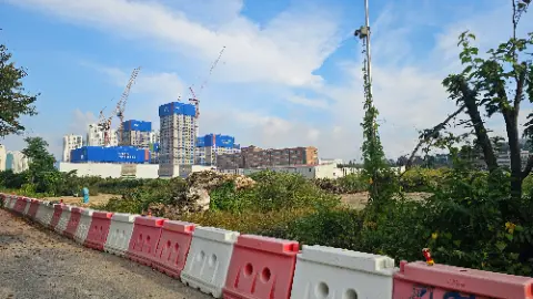 A construction site with a large building and a pile