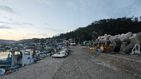A dock with a boat and a rock wall