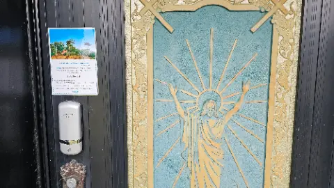 A doorway with a picture of Jesus on it