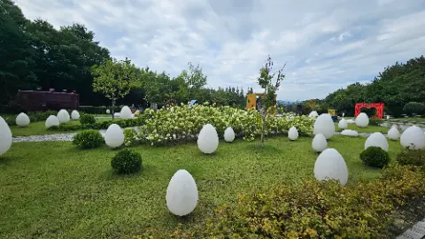 A garden with white eggs and trees