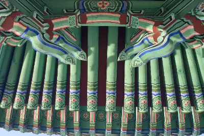 A green and blue decorative roof with a dragon design