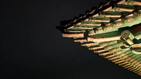 A green and white roof with a dark background