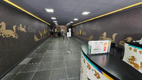 A group of people are standing in a long hallway