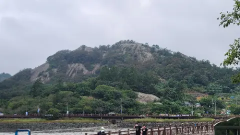 A group of people are standing on a bridge overlooking