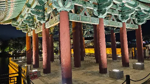 A group of red pillars with green designs on them