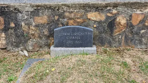 A headstone for William C. Lansing is in a grassy