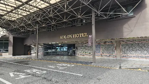 A hotel with a large sign in front of it