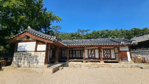 A house with a gray roof and a white wall