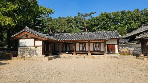 A house with a tiled roof and a wooden fence
