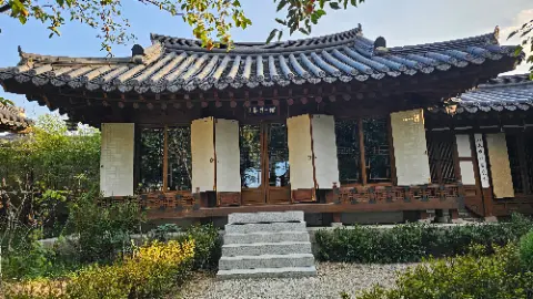 A house with a white roof and a wooden fence