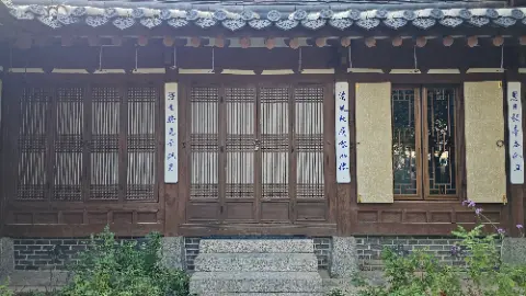 A house with a wooden door and a window with