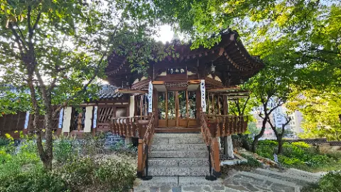 A house with a wooden staircase and a roof with