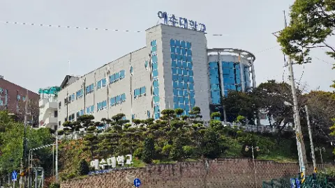 A large building with a blue roof and a sign