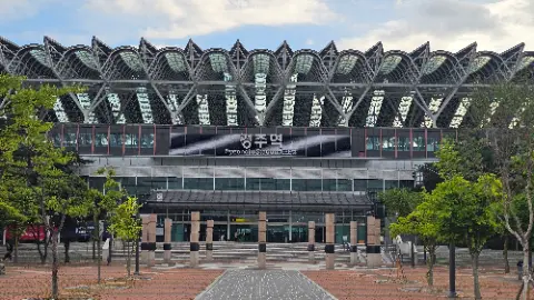 A large building with a glass roof and a sign