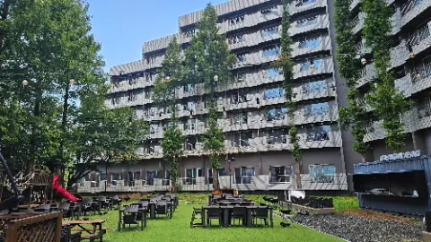 A large building with a patio area and many chairs