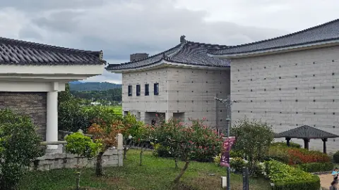 A large building with a red roof and a black