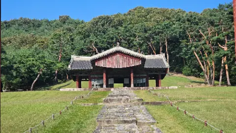 A large building with a red roof and a white