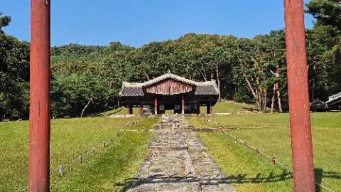 A large building with a red roof and a white