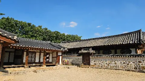 A large building with a stone roof and a wooden