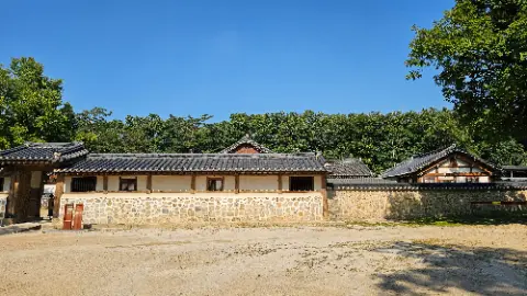 A large building with a tile roof and a stone