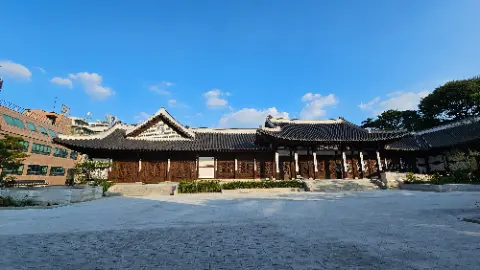 A large building with a white roof and a blue